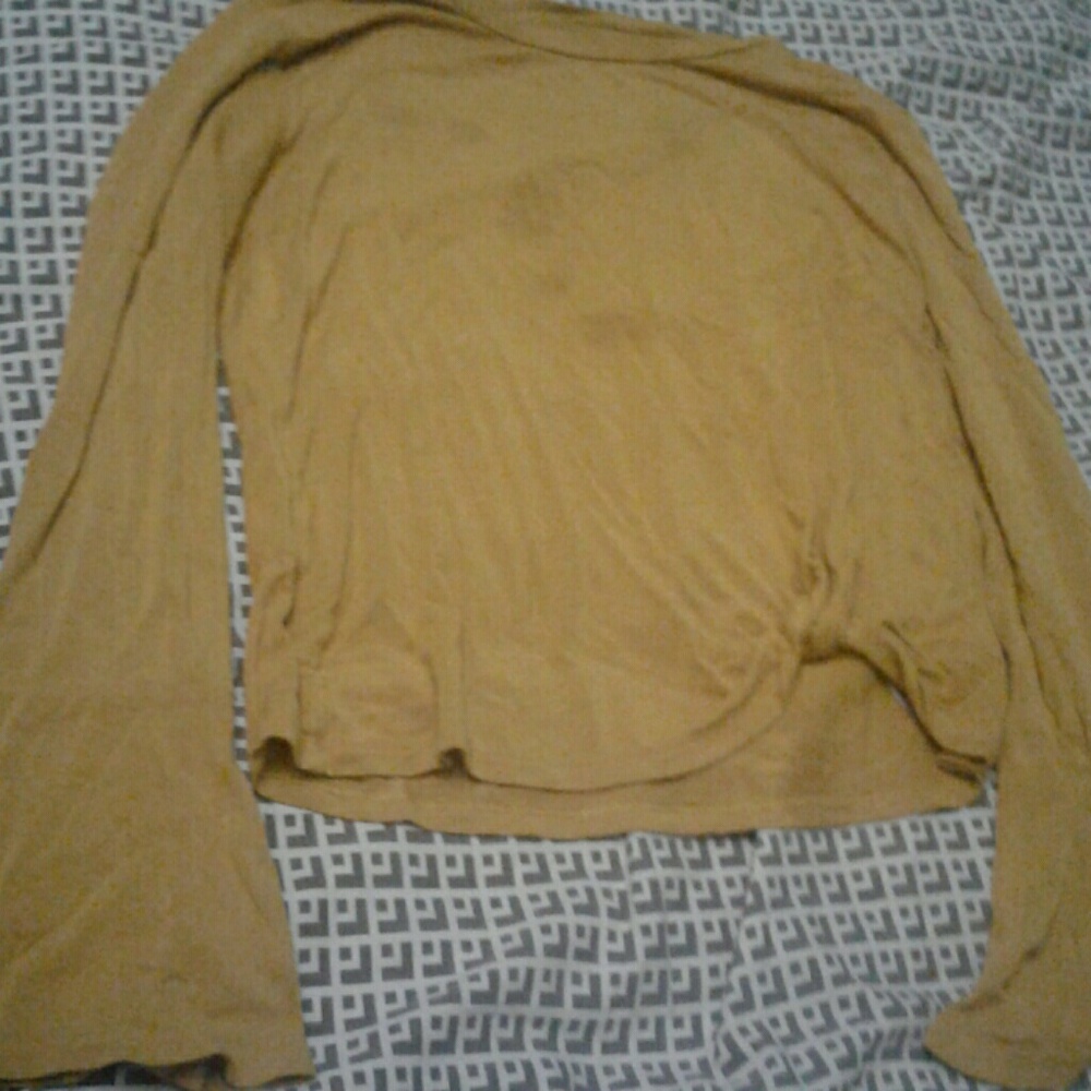 A gold shirt with a tie